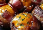 Cheddar-stuffed BBQ bacon bombs on a grill, sizzling with flavor