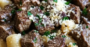 Delicious garlic butter steak bites served with creamy parmesan shells