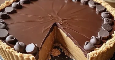 Giant Reese's Peanut Butter Cup Pie topped with chocolate and peanut butter.