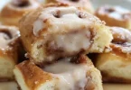 Freshly baked King's Hawaiian cinnamon rolls with icing on top.