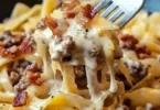 Loaded Bacon Cheeseburger Alfredo Pasta topped with crispy bacon and cheese