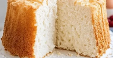 Old fashioned Angel Food Cake topped with fresh strawberries and whipped cream