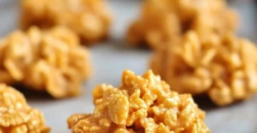 Freshly baked peanut butter cornflake cookies on a plate