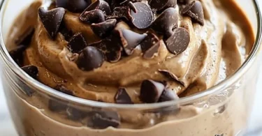 Delicious Peanut Butter Cup Protein Mousse topped with chocolate and peanuts