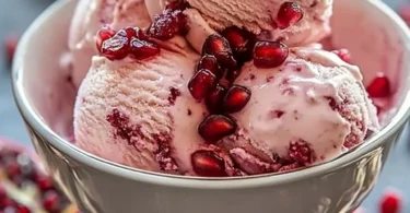 Delicious bowl of pomegranate ice cream garnished with fresh pomegranate seeds