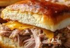 Delicious Slow Cooker Cuban Sandwiches served with pickles and mustard
