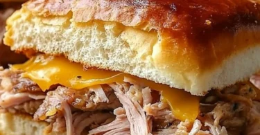 Delicious Slow Cooker Cuban Sandwiches served with pickles and mustard