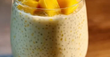 Delicious creamy mango sago dessert topped with fresh mango slices.