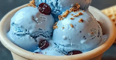 A scoop of Blue Moon Ice Cream in a colorful cone, showcasing its vibrant blue hue.