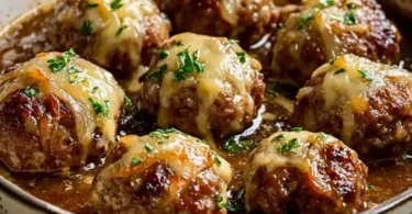 Cheesy French onion meatballs served with melted cheese and caramelized onions