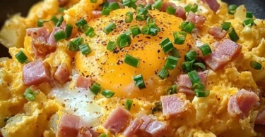 Cheesy potato egg scramble served in a bowl with fresh herbs