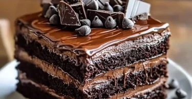 Delicious Chocolate Fudge Layered Cake topped with chocolate ganache and sprinkles