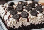 Delicious Cookies & Cream Poke Cake with cream filling and cookie crumbs