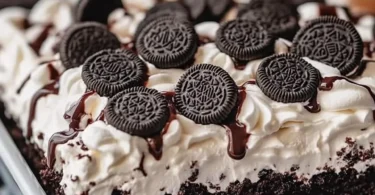 Delicious Cookies & Cream Poke Cake with cream filling and cookie crumbs