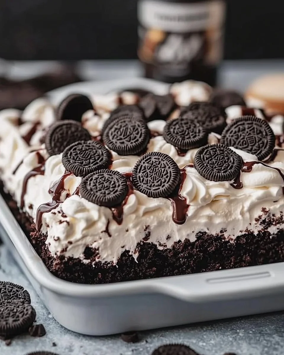 Delicious Cookies & Cream Poke Cake with cream filling and cookie crumbs