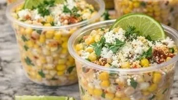 Delicious creamy Mexican street corn cups topped with cheese and spices.