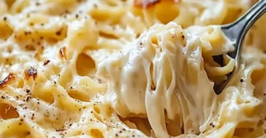 Creamy noodles Romanoff topped with herbs and spices in a bowl