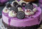 Decadent Ube Oreo Cheesecake topped with crushed Oreos and ube flavor
