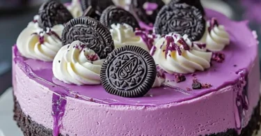 Decadent Ube Oreo Cheesecake topped with crushed Oreos and ube flavor