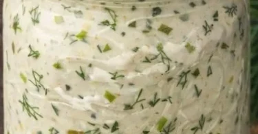 Delicious Dill Pickle Dip served with crackers and vegetables