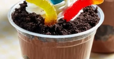 Delicious and fun dirt cups dessert with chocolate, gummy worms, and crushed cookies.