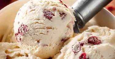 A scoop of Bunny Pepper Ice Cream in a cone, featuring vibrant colors and toppings.