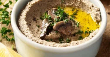 Easy 20 Minute Mushroom Pâté on a rustic wooden table with fresh herbs