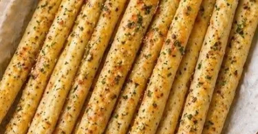 Thin and crispy garlic bread sticks served as a tasty appetizer