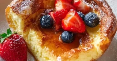 Delicious fluffy German pancakes served with syrup and berries