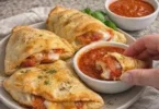 Golden cheesy calzones filled with gooey cheese and savory ingredients