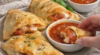 Golden cheesy calzones filled with gooey cheese and savory ingredients