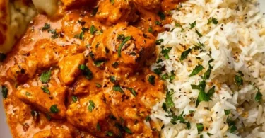 Delicious homemade butter chicken served with rice and naan.