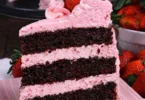 Homemade dark chocolate cake with strawberry buttercream frosting