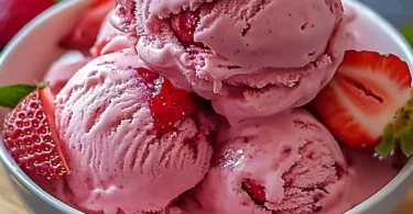 Delicious homemade strawberry ice cream in a bowl with fresh strawberries