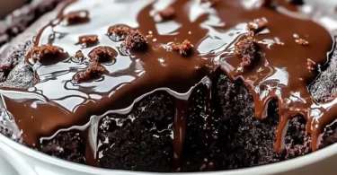 Hot Fudge Chocolate Pudding Cake topped with chocolate drizzle and whipped cream