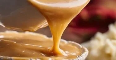 Delicious bowl of KFC Gravy served with fried chicken and biscuits