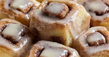Freshly baked King's Hawaiian cinnamon rolls topped with creamy frosting