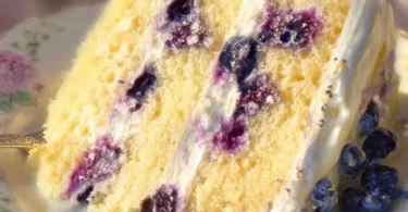 Slice of Lemon Blueberry Cake topped with fresh blueberries