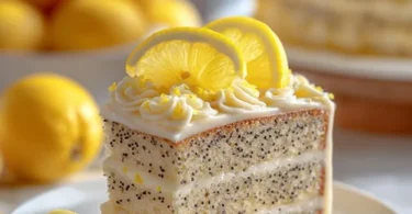 Sliced lemon poppy seed cake garnished with lemon zest and poppy seeds