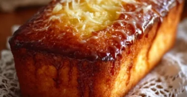 Slice of moist Lemon Yogurt Cake topped with lemon glaze