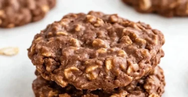 Delicious no bake cookies served on a plate with chocolate drizzle.