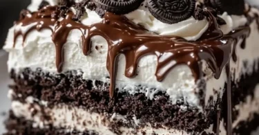 Delicious Nutella Oreo Poke Cake topped with crushed Oreos and drizzled with Nutella