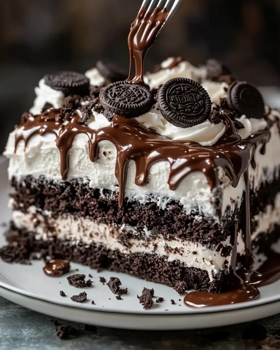 Delicious Nutella Oreo Poke Cake topped with crushed Oreos and drizzled with Nutella