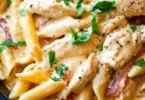 Delicious Olive Garden Chicken Pasta served in a bowl with fresh ingredients.