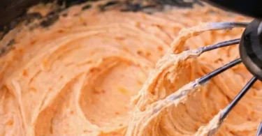 Delicious orange creamsicle buttercream icing beautifully swirled on a cake