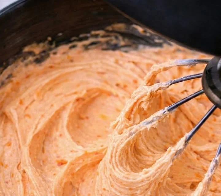 Delicious orange creamsicle buttercream icing beautifully swirled on a cake