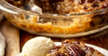 A slice of Pecan Pie Cake topped with whipped cream and pecans