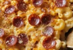 A delicious dish of Pizza Macaroni and Cheese topped with melted cheese and pepperoni.