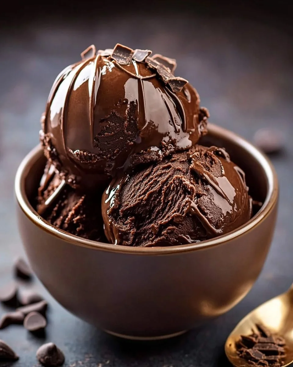 Rich homemade chocolate ice cream in a bowl with chocolate shavings on top.