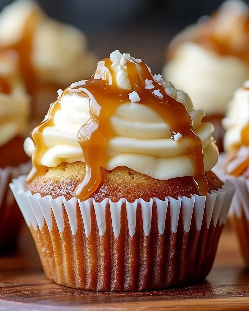 Salted caramel cream cheese cupcakes topped with caramel drizzle and sprinkles